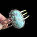 holding tilted front view chunky everyday turquoise bracelet, sterling silver and stamped